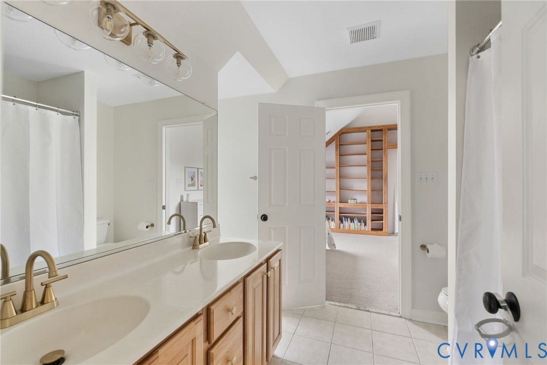 12305 Bradford Landing Way, Wyndham, Glen Allen, VA 23059 Joint Shared Bath with 2 front bedrooms featuring a double vanity with light wood cabinetry, white countertop, and brass-finish faucets
