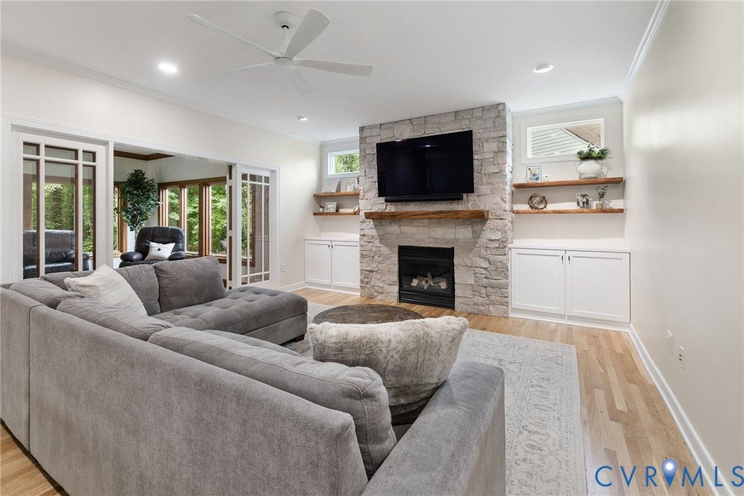 12305 Bradford Landing Way, Wyndham, Glen Allen, VA 23059 Renovated featuring a stone-clad gas fireplace with a custom wood mantel, built-in cabinetry, wood-finish flooring, and a ceiling fan, recessed lights and two new windows added