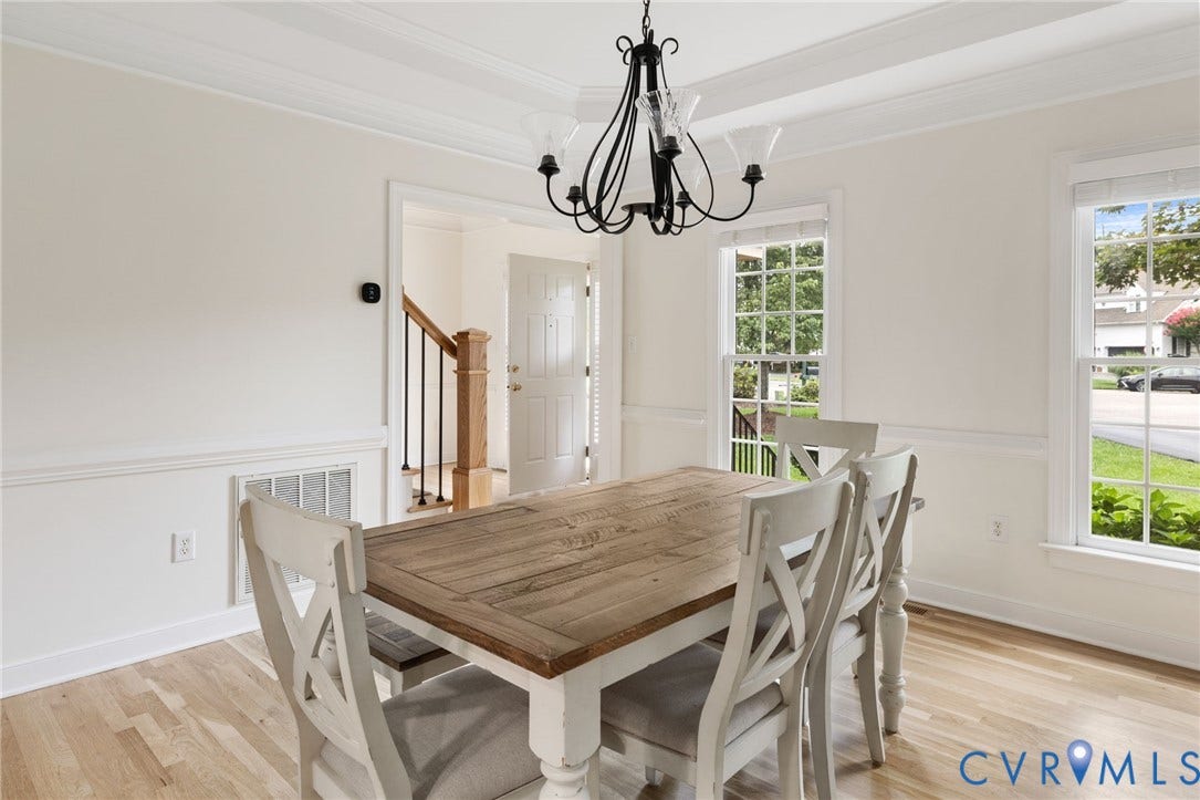 12305 Bradford Landing Way, Wyndham, Glen Allen, VA 23059 Formal Dining Room light wood-finish flooring, white walls with wainscoting, and crown molding with new chandilier