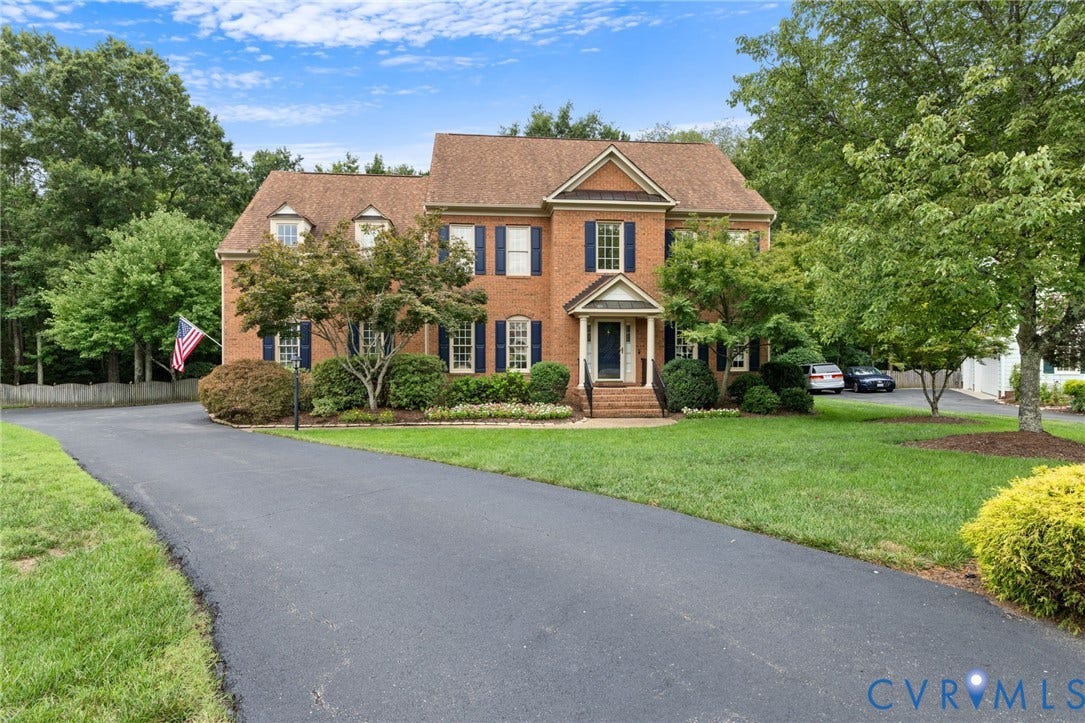 12305 Bradford Landing Way, Wyndham, Glen Allen, VA 23059 Brick exterior residence featuring a gabled roof, dormer windows, and dark shutters