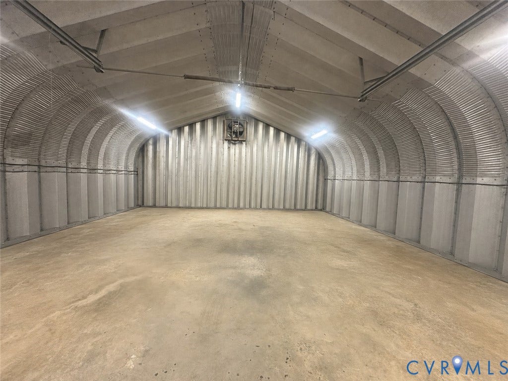 3927 Hughes Creek Road, Powhatan, VA 23139 Corrugated metal interior with high arched ceilings, concrete flooring, and built-in overhead lighting