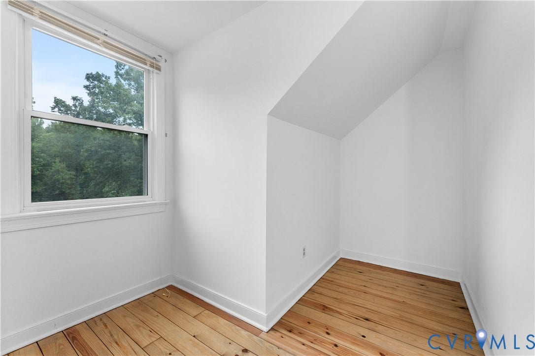 3927 Hughes Creek Road, Powhatan, VA 23139 Hardwood flooring, white painted walls, white trim, and a double-hung window