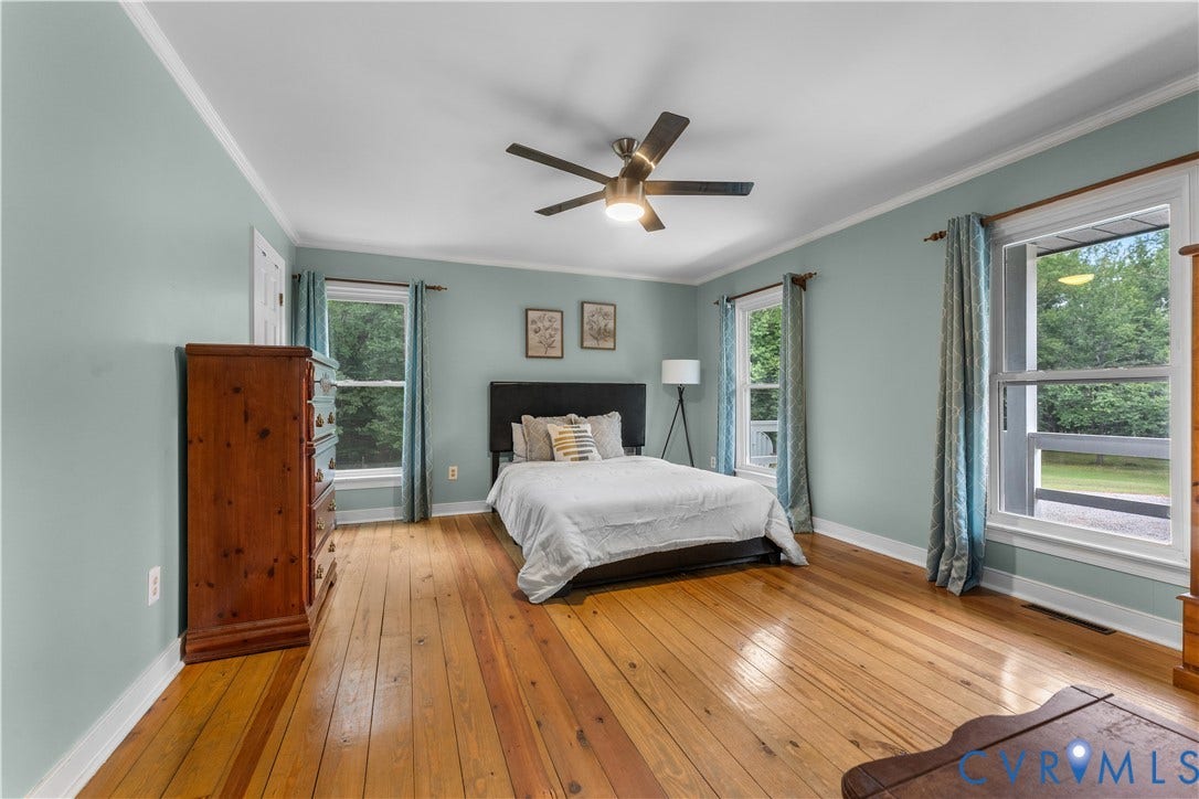 3927 Hughes Creek Road, Powhatan, VA 23139 Hardwood flooring, painted walls, crown molding, ceiling fan, and multiple windows