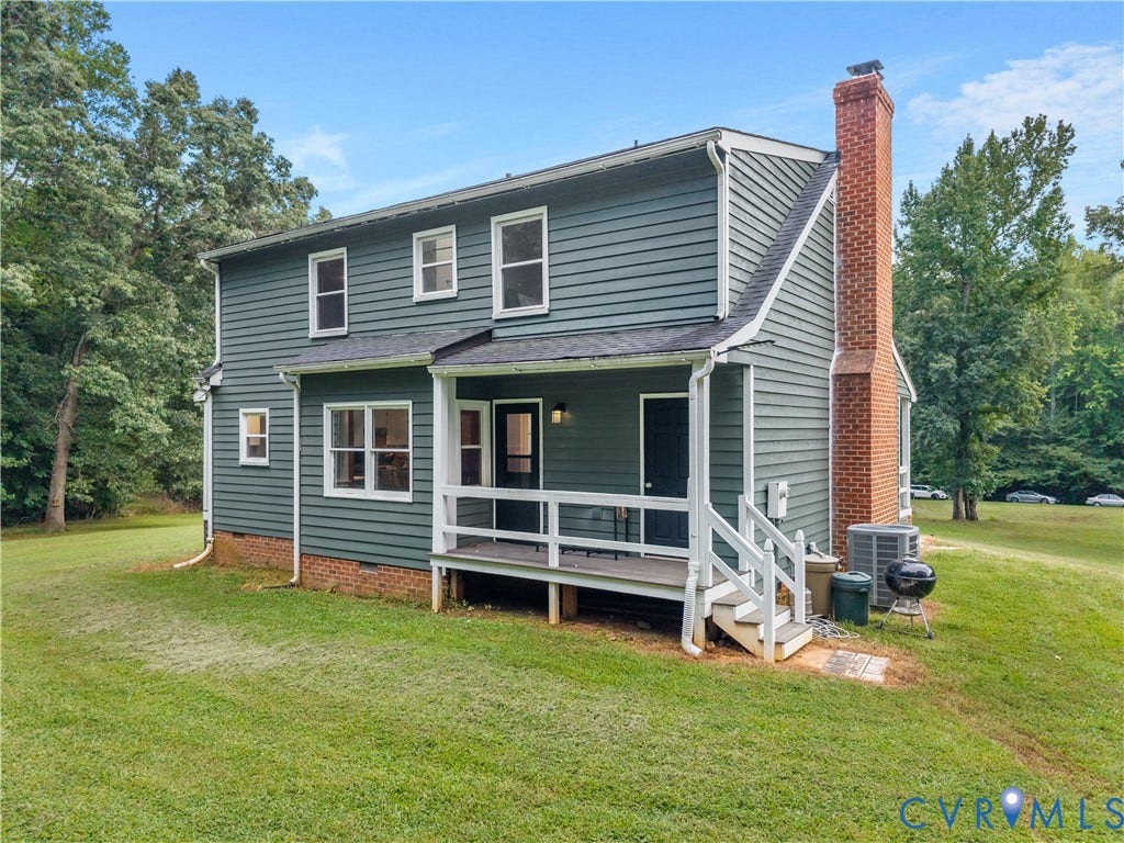3927 Hughes Creek Road, Powhatan, VA 23139 Two-story exterior with dark siding, white trim, red brick chimney, covered porch, and white railings