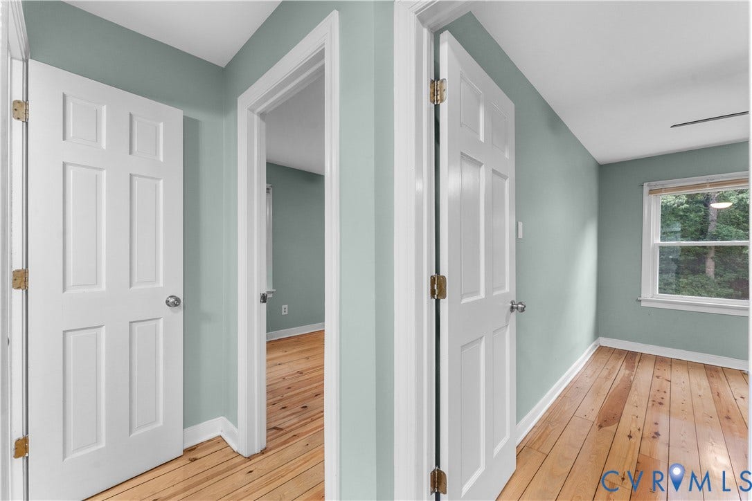 3927 Hughes Creek Road, Powhatan, VA 23139 Light wood-finish flooring with white trim, a single window, and a paneled door