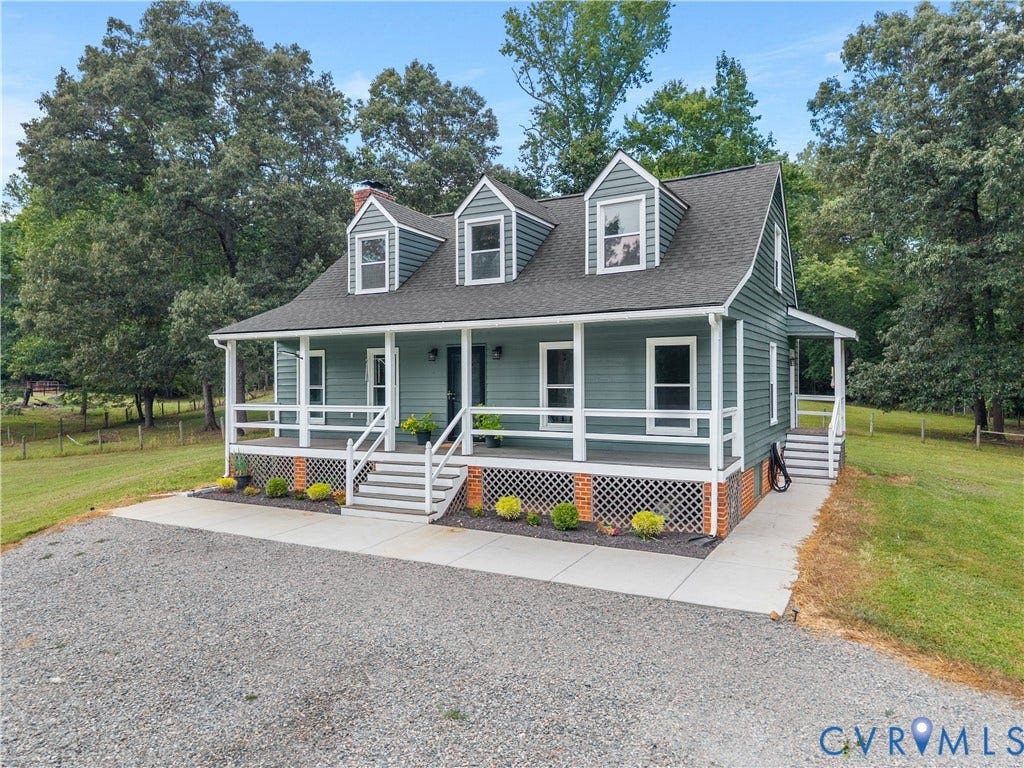 3927 Hughes Creek Road, Powhatan, VA 23139 Dormer windows, covered front porch, exterior siding, white porch railings, and a gravel driveway
