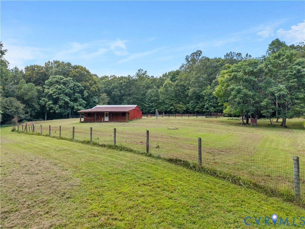 3927 Hughes Creek Road, Powhatan, VA 23139 Expansive green space with perimeter fencing and a red barn structure