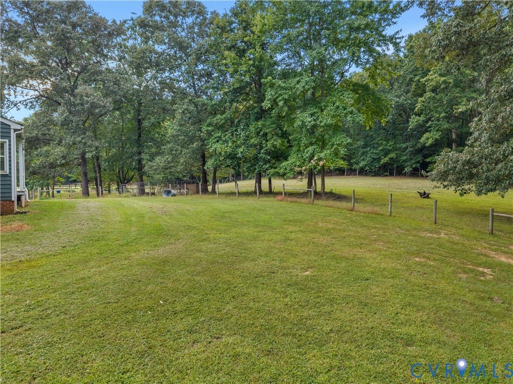 3927 Hughes Creek Road, Powhatan, VA 23139 Expansive grassy area with a partial fence line and mature trees
