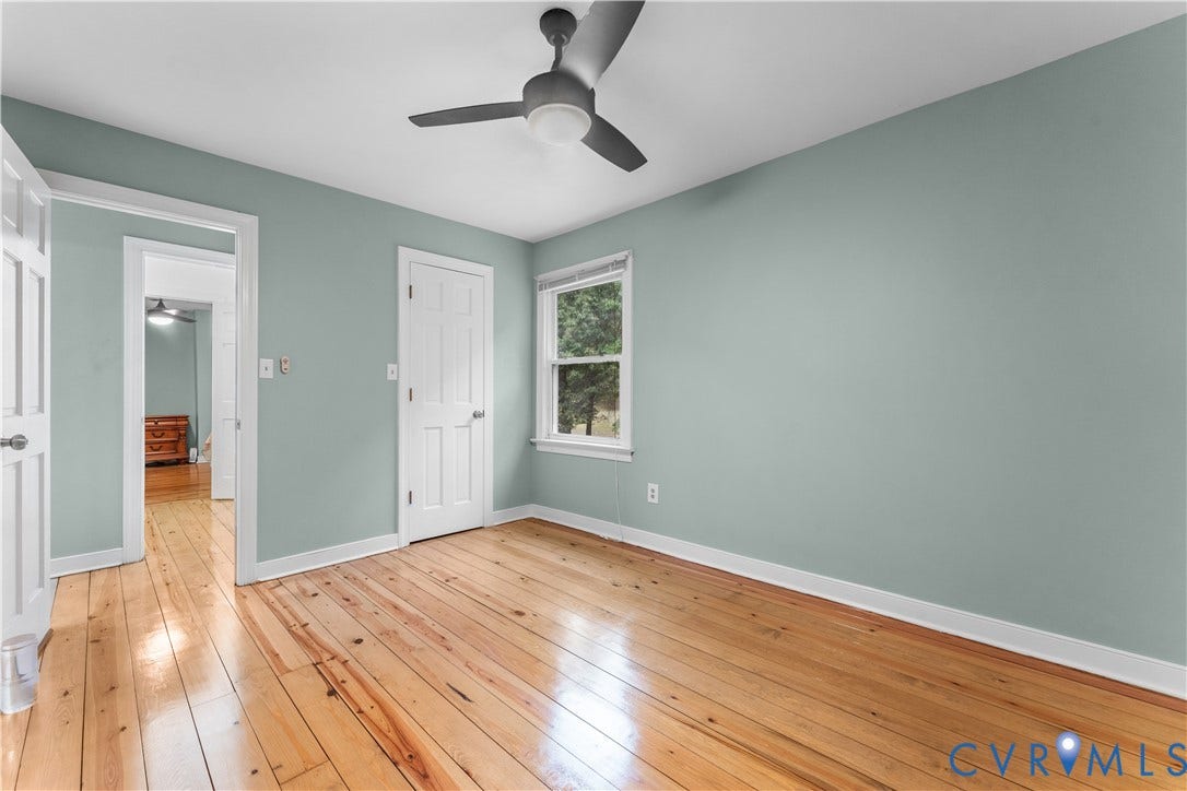 3927 Hughes Creek Road, Powhatan, VA 23139 Hardwood flooring with a natural finish, white trim, and a ceiling fan with integrated lighting