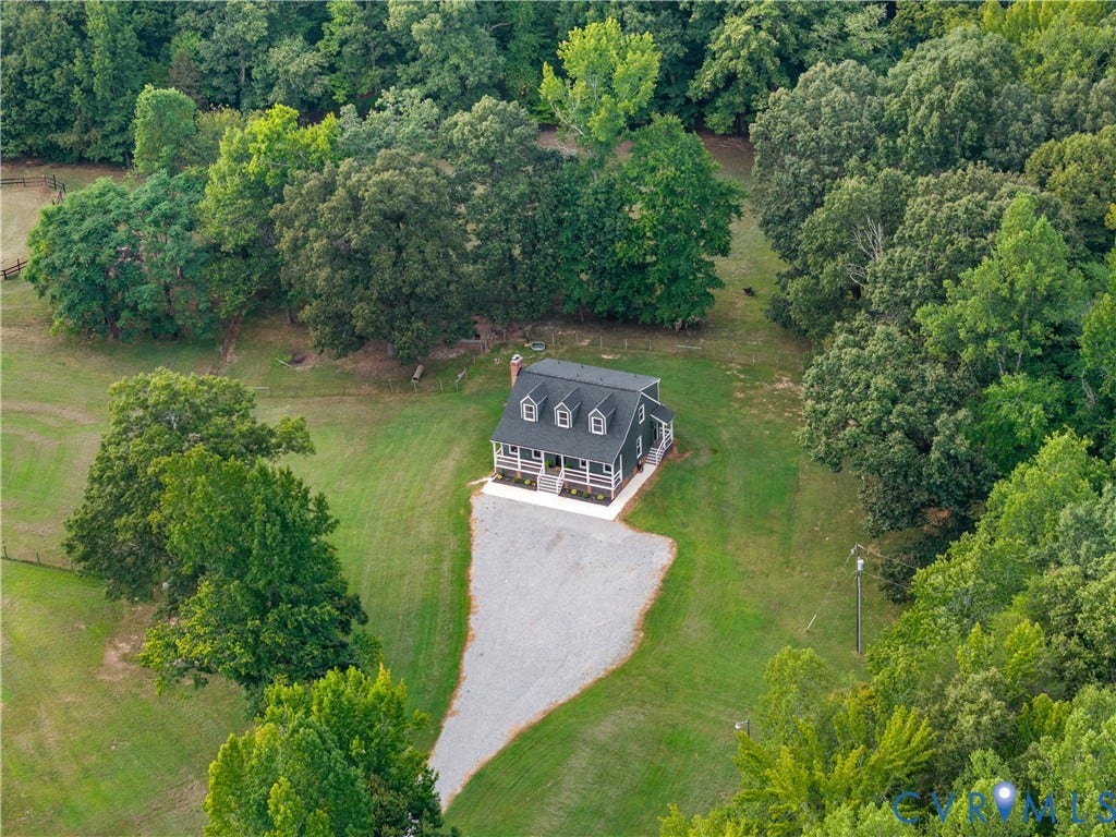 3927 Hughes Creek Road, Powhatan, VA 23139 Exterior featuring a dark gray facade, white trim, multiple dormer windows, a covered front porch with white columns, and a light-colored gravel driveway