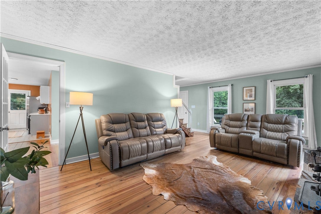 3927 Hughes Creek Road, Powhatan, VA 23139 Hardwood flooring, light-toned wall paint, white trim, and multiple windows
