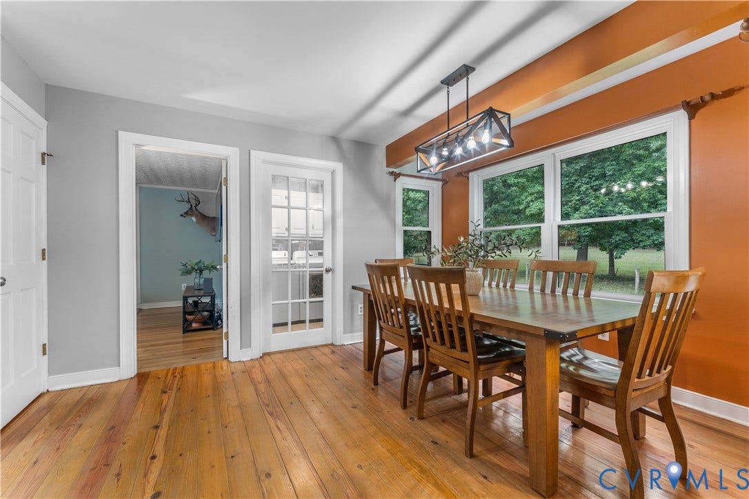 3927 Hughes Creek Road, Powhatan, VA 23139 Hardwood flooring, recessed doorway, French doors, large windows, and a rectangular linear chandelier