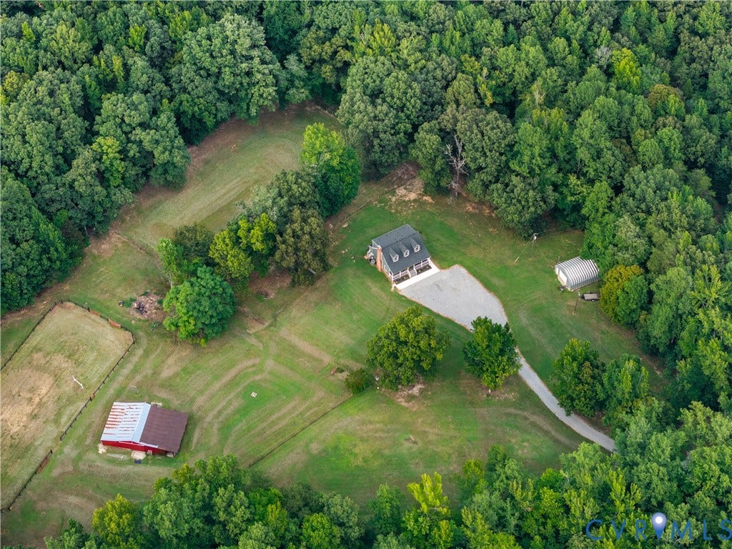 3927 Hughes Creek Road, Powhatan, VA 23139 Expansive property featuring a residence, gravel driveway, mature trees, and a red barn