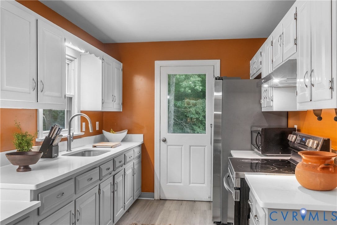 3927 Hughes Creek Road, Powhatan, VA 23139 White cabinetry with contrasting lower cabinets, light-toned countertops, and wood-finish flooring