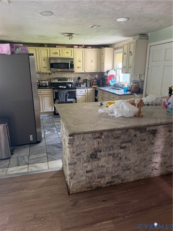 Kitchen featuring a stone-look island with a solid surface countertop