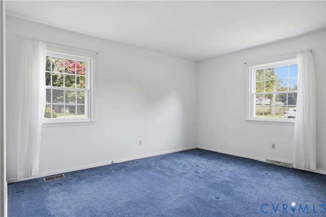 3641 Kiefer Road, Bermuda, Chester, VA 23831 Interior room featuring two multi-pane windows, white walls, and blue carpeting