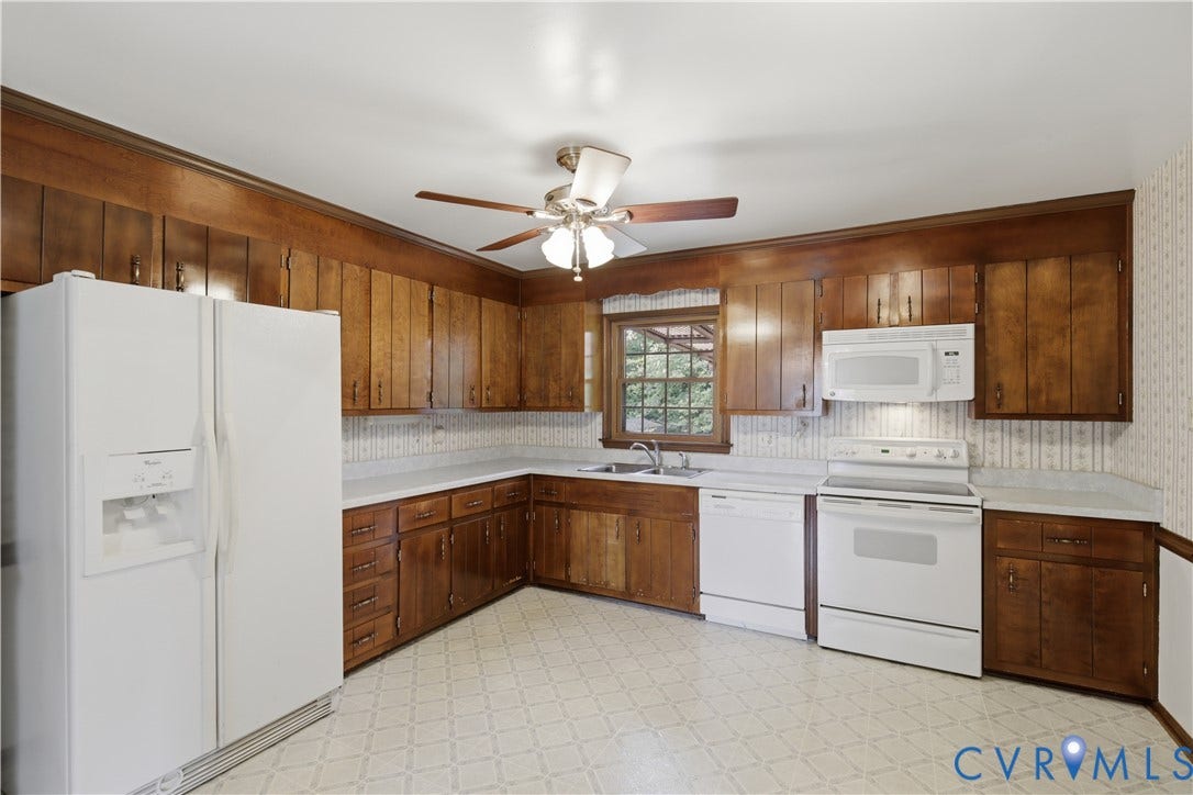 3641 Kiefer Road, Bermuda, Chester, VA 23831 Kitchen featuring extensive wood cabinetry, white countertops, built-in appliances, a window above the sink, and patterned flooring