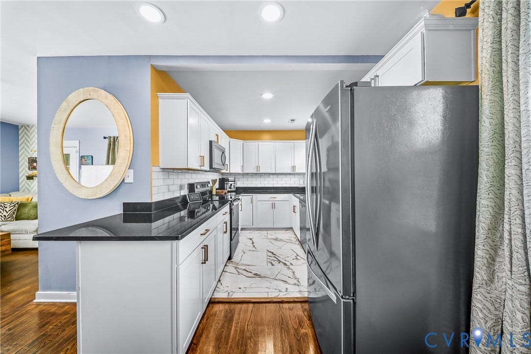 3304 Carlton Road, Henrico, VA 23223 Modern kitchen featuring white cabinetry, black countertops, stainless steel appliances, a white subway tile backsplash, and recessed lighting