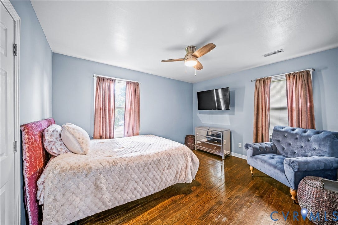 3304 Carlton Road, Henrico, VA 23223 Bedroom #1 featuring wood flooring, a ceiling fan with integrated lighting, and two windows with drapery