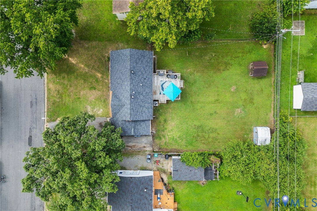 3304 Carlton Road, Henrico, VA 23223 Spacious property featuring a large backyard with manicured lawn, a multi-level wood deck, and mature perimeter trees