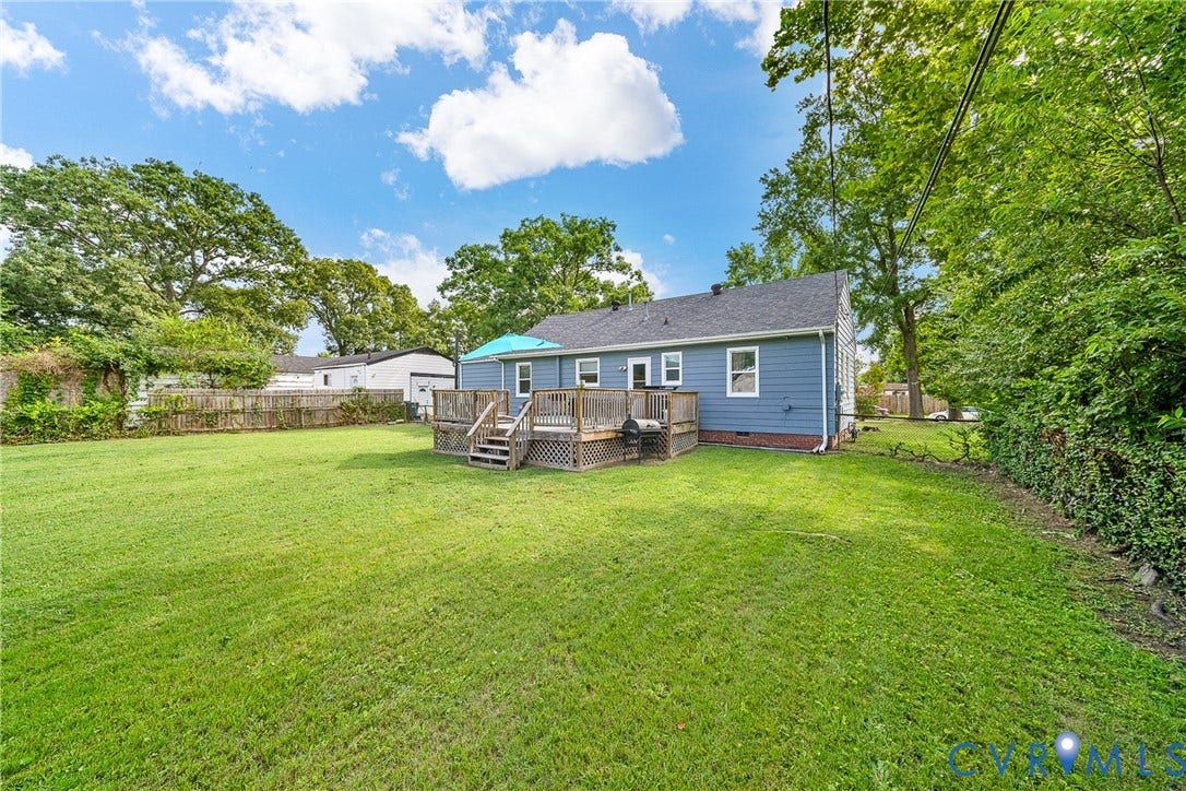 3304 Carlton Road, Henrico, VA 23223 Expansive rear yard featuring a large wooden deck and a mature tree line
