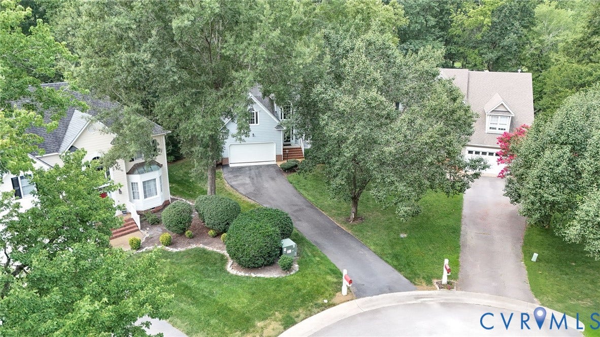 Aerial perspective showcasing a residential street with three distinct properties