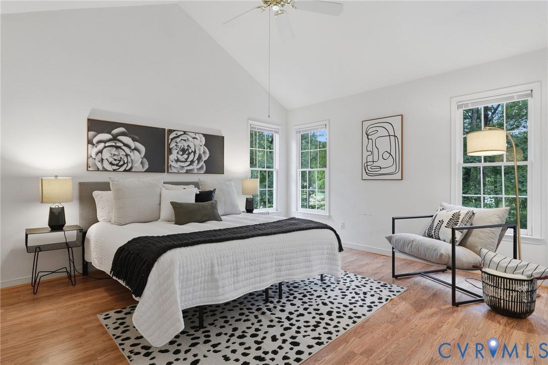 Bedroom featuring a vaulted ceiling with a ceiling fan, wood-finish flooring, and multiple windows