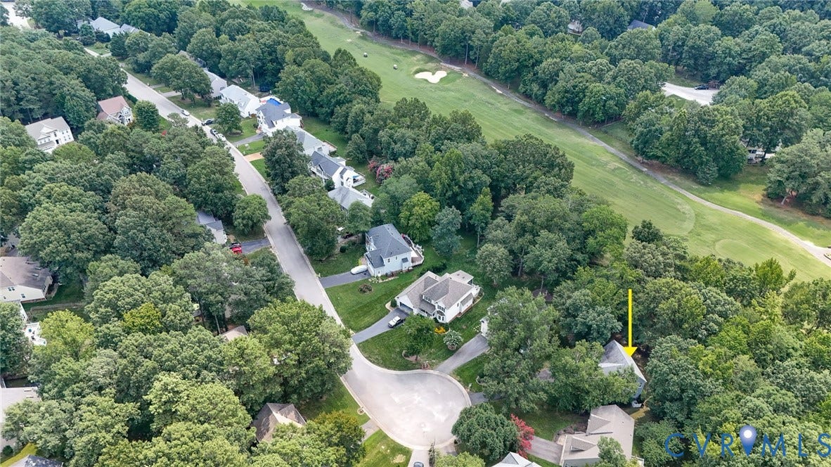 Residential neighborhood featuring mature trees and proximity to a golf course