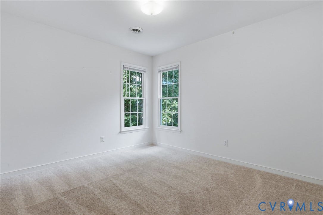 Neutral tone wall finishes paired with light-colored carpeting