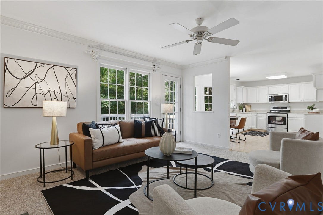 Bright living area featuring a ceiling fan, crown molding, and direct access to an outdoor space