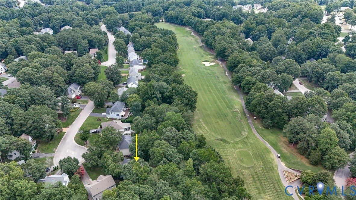 Aerial perspective showcasing a residential area bordered by a golf course