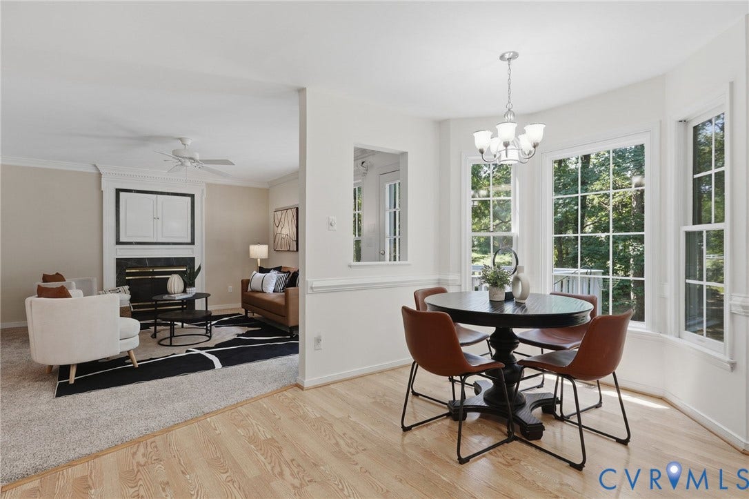Bay window dining area featuring wood-finish flooring