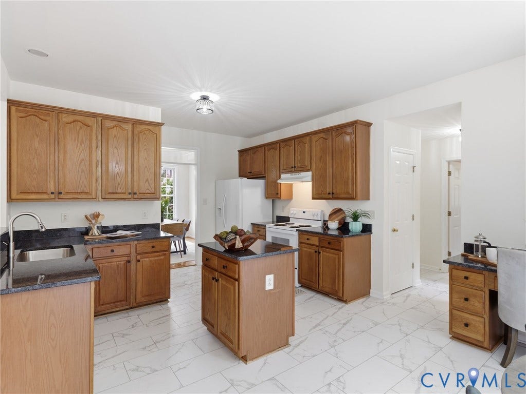 5707 Stephens Point Court, Chesterfield, VA 23831 Bright, open Kitchen with dark granite countertops, wood cabinets and updated flooring.