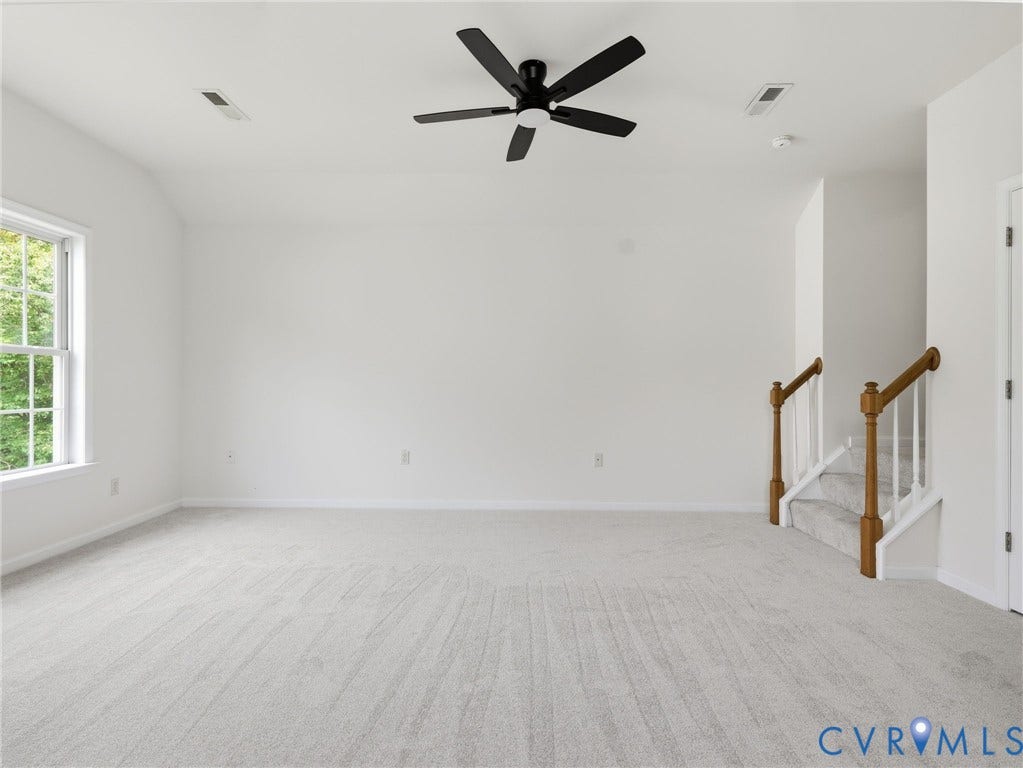 5707 Stephens Point Court, Chesterfield, VA 23831 Expansive room featuring light-toned carpeting, a black ceiling fan, and a large window with exterior greenery