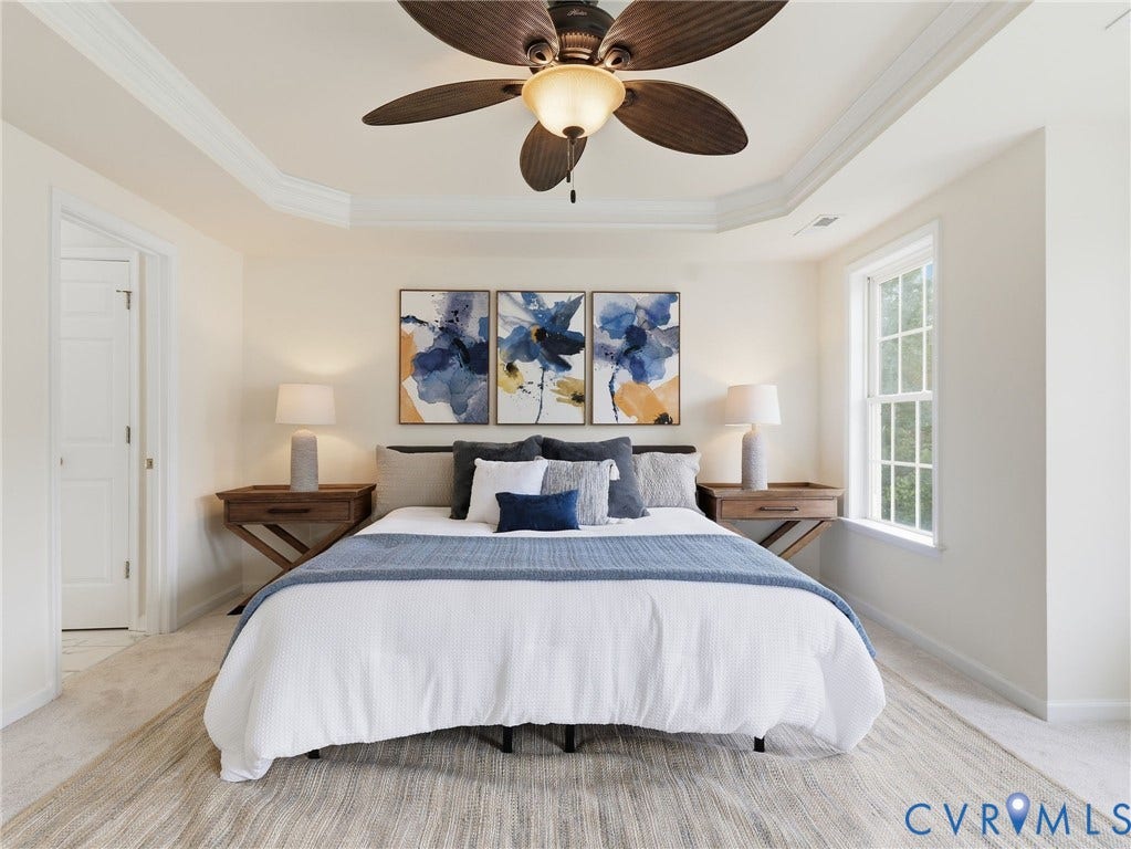 5707 Stephens Point Court, Chesterfield, VA 23831 Spacious Primary Bedroom featuring a tray ceiling with crown molding, wood-finish ceiling fan, and light-colored wall-to-wall carpeting.
