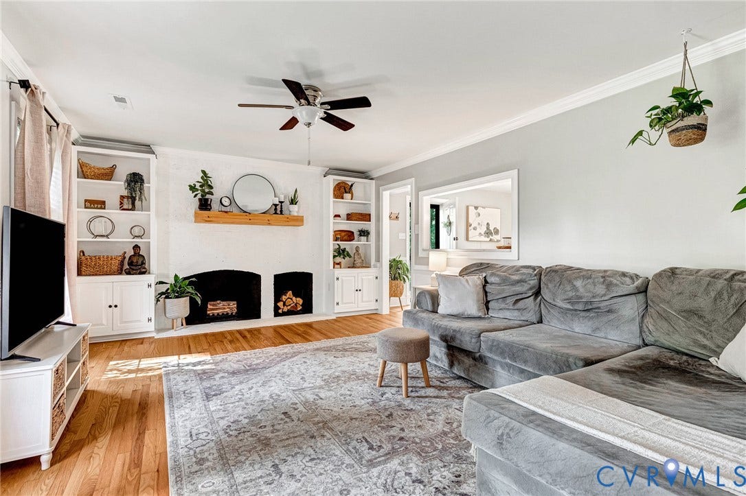 8800 Shewsbury Drive, New Kent, VA 23124 Living area featuring wood-finish flooring, a ceiling fan, crown molding, and a built-in fireplace with a wood mantle and surrounding built-in shelving