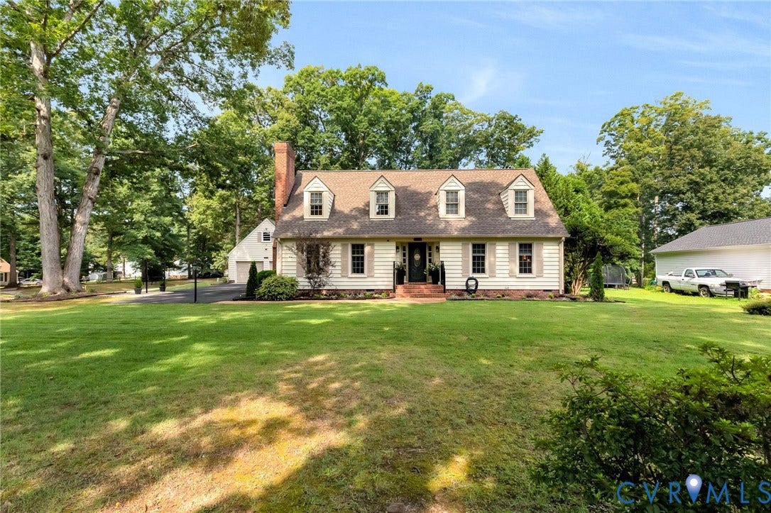 8800 Shewsbury Drive, New Kent, VA 23124 Traditional Cape Cod residence featuring a dormered roofline, brick chimney, and light-toned siding