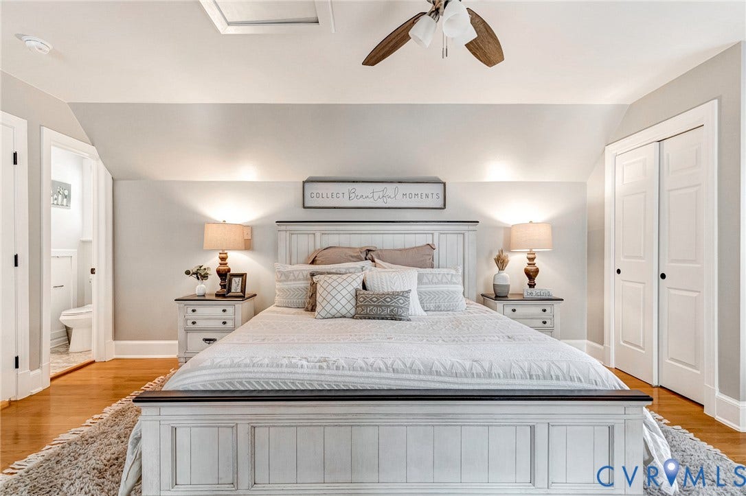 8800 Shewsbury Drive, New Kent, VA 23124 Bedroom featuring hardwood flooring, a ceiling fan with light fixture, built-in bi-fold closet doors, and an entry to an adjacent bathroom with tile flooring and a toilet