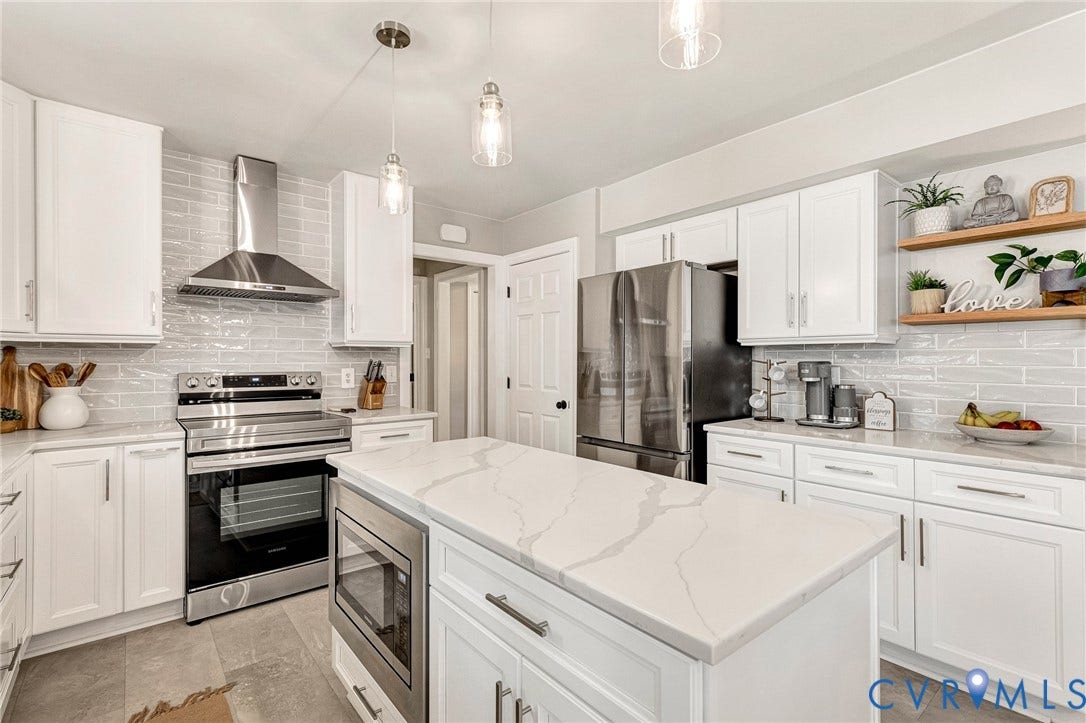 8800 Shewsbury Drive, New Kent, VA 23124 Kitchen featuring a central island with a quartz countertop, white cabinetry, stainless steel appliances, pendant lighting, and a subway tile backsplash