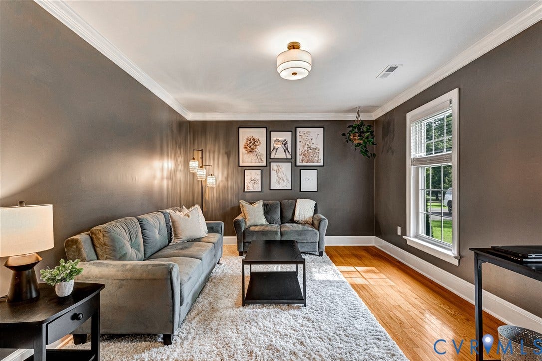 8800 Shewsbury Drive, New Kent, VA 23124 Living area featuring wood-finish flooring, crown molding, and a double-hung window with white blinds
