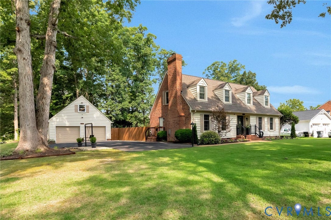8800 Shewsbury Drive, New Kent, VA 23124 Dormered residence featuring a partial brick facade, white siding, and a prominent brick chimney