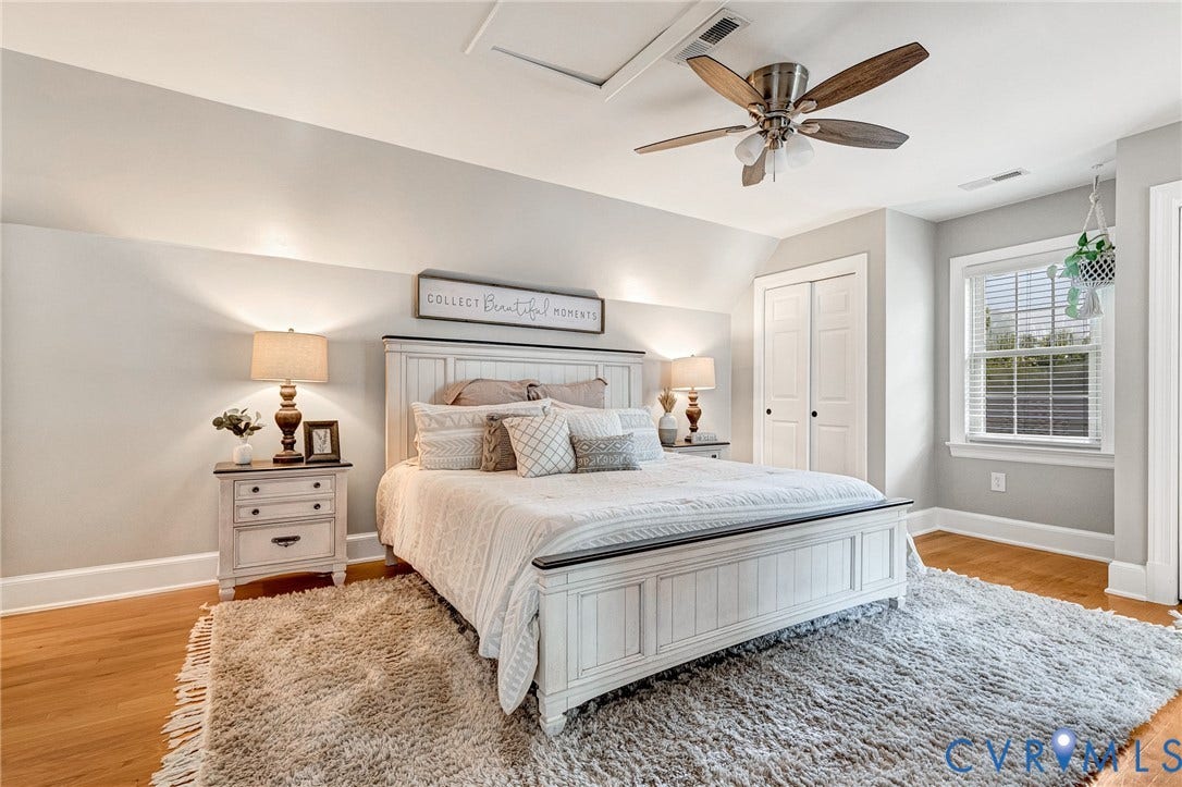 8800 Shewsbury Drive, New Kent, VA 23124 Bright room featuring hardwood-style flooring, a multi-pane window with blinds, and a ceiling fan with light fixture