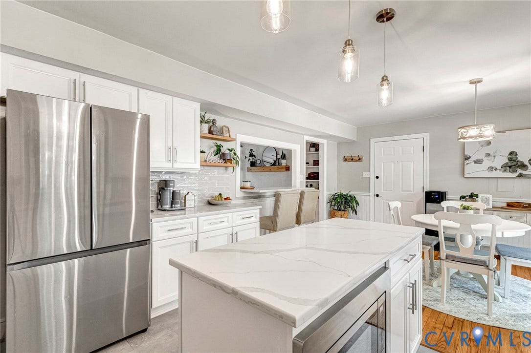 8800 Shewsbury Drive, New Kent, VA 23124 Kitchen featuring an oversized center island with a quartz countertop, white cabinetry, stainless steel appliances, and pendant lighting
