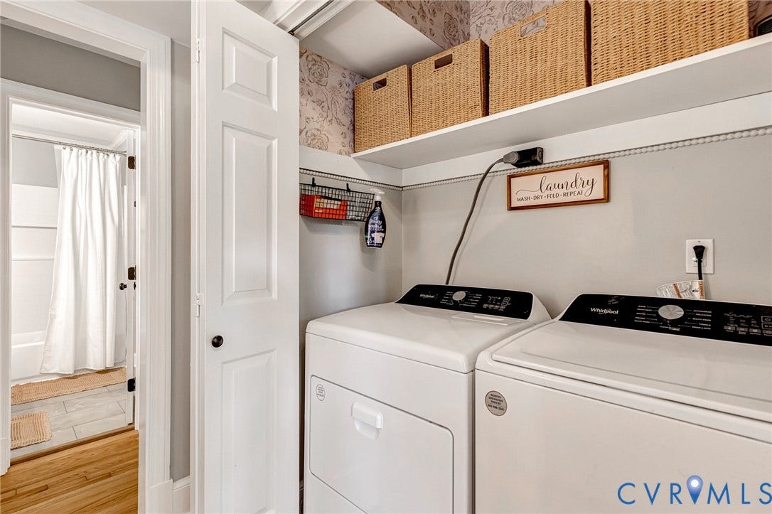 8800 Shewsbury Drive, New Kent, VA 23124 Dedicated laundry area featuring a white washer and dryer set, an upper storage shelf, and light-toned wall paneling