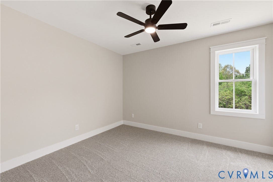 Carpeted room with a ceiling fan, light neutral wall paint, white trim, and a double-hung window