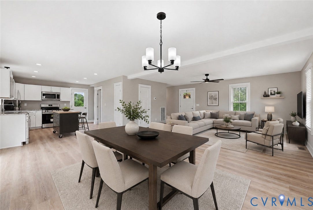 Open-concept living space featuring wood-finish flooring, recessed lighting, and neutral wall tones Viturally staged