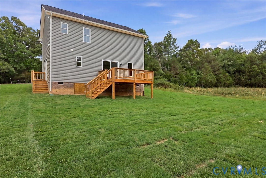 Expansive grassy yard with mature tree line