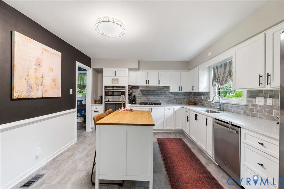 404 Aubery Road, Henrico, VA 23229 Kitchen featuring a white cabinetry, wood-top island, stainless steel appliances, light gray flooring, and subway tile backsplash