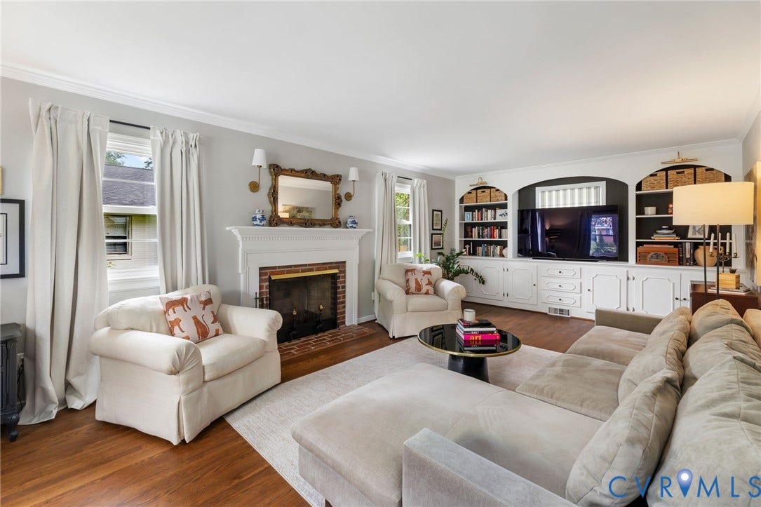 404 Aubery Road, Henrico, VA 23229 Living area featuring refinished hardwood flooring, a brick-surround fireplace with a white mantel, and built-in cabinetry with integrated shelving