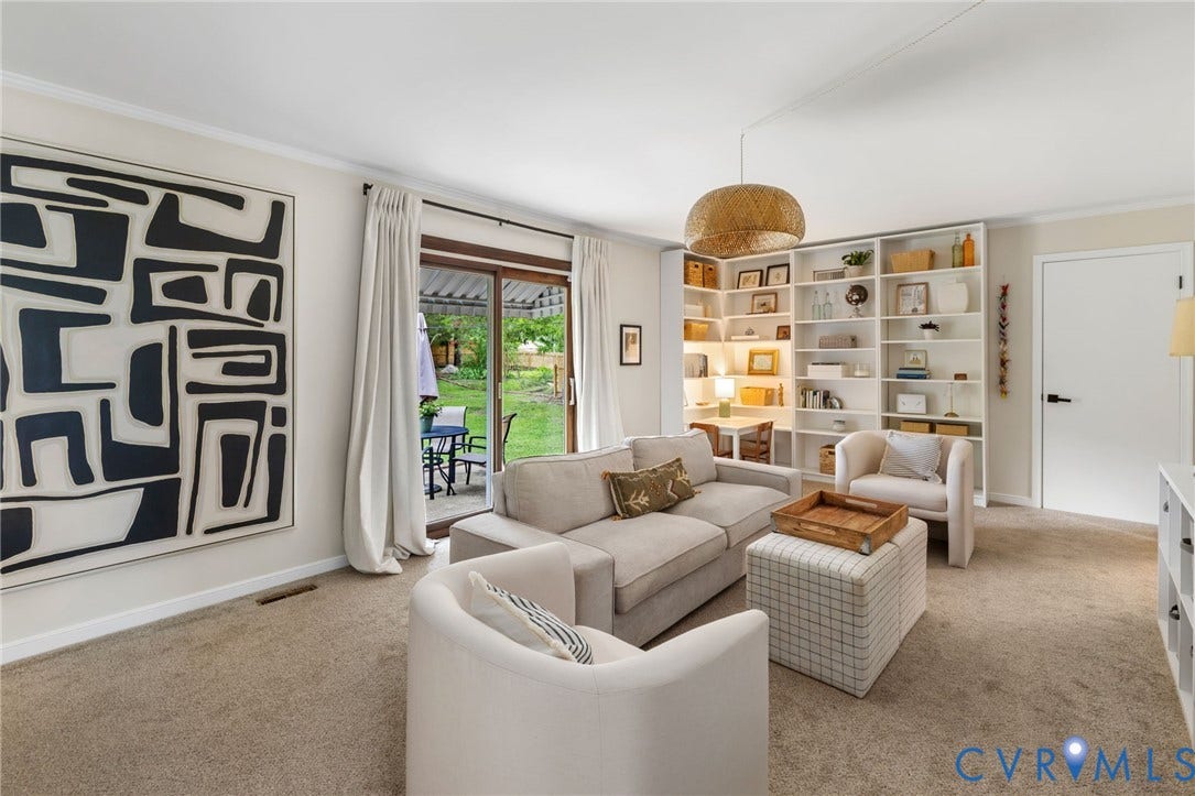 404 Aubery Road, Henrico, VA 23229 Living area featuring a spacious shelving unit, a sliding glass door to the exterior, and light-colored carpeting